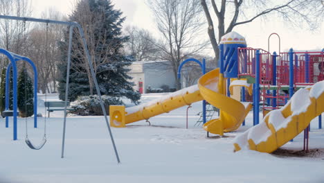 empty snow-covered playground in the middle of winter