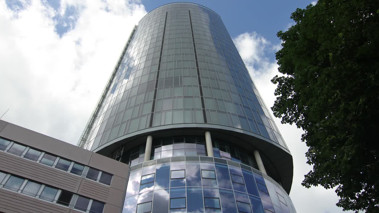 Timelapse - 4k - reflections of clouds and blue sky on a round building in Cologne, Germany