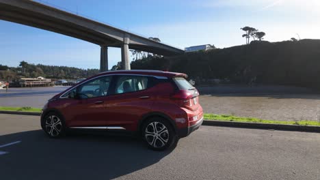 gimbal panning shot of an electric vehicle parked under the noyo bridge in fort bragg, california. 4k