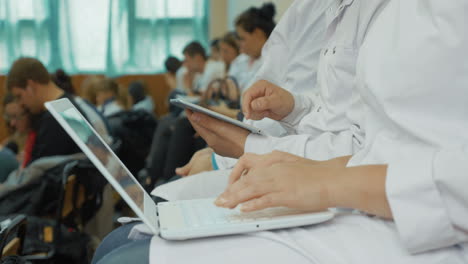 medical students using laptop and pad on the lecture