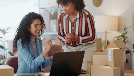 Designer-women,-high-five-and-laptop-at-fashion