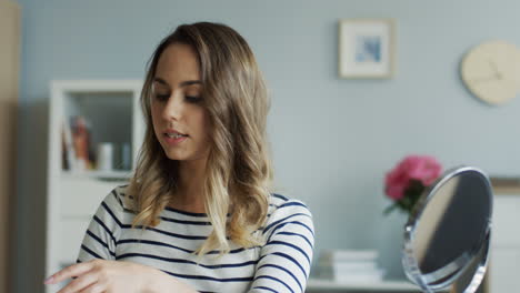 portrait of a pretty beauty blogger recording a makeup tutorial video and talking about foundation application