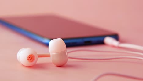 pink headphones and smartphone