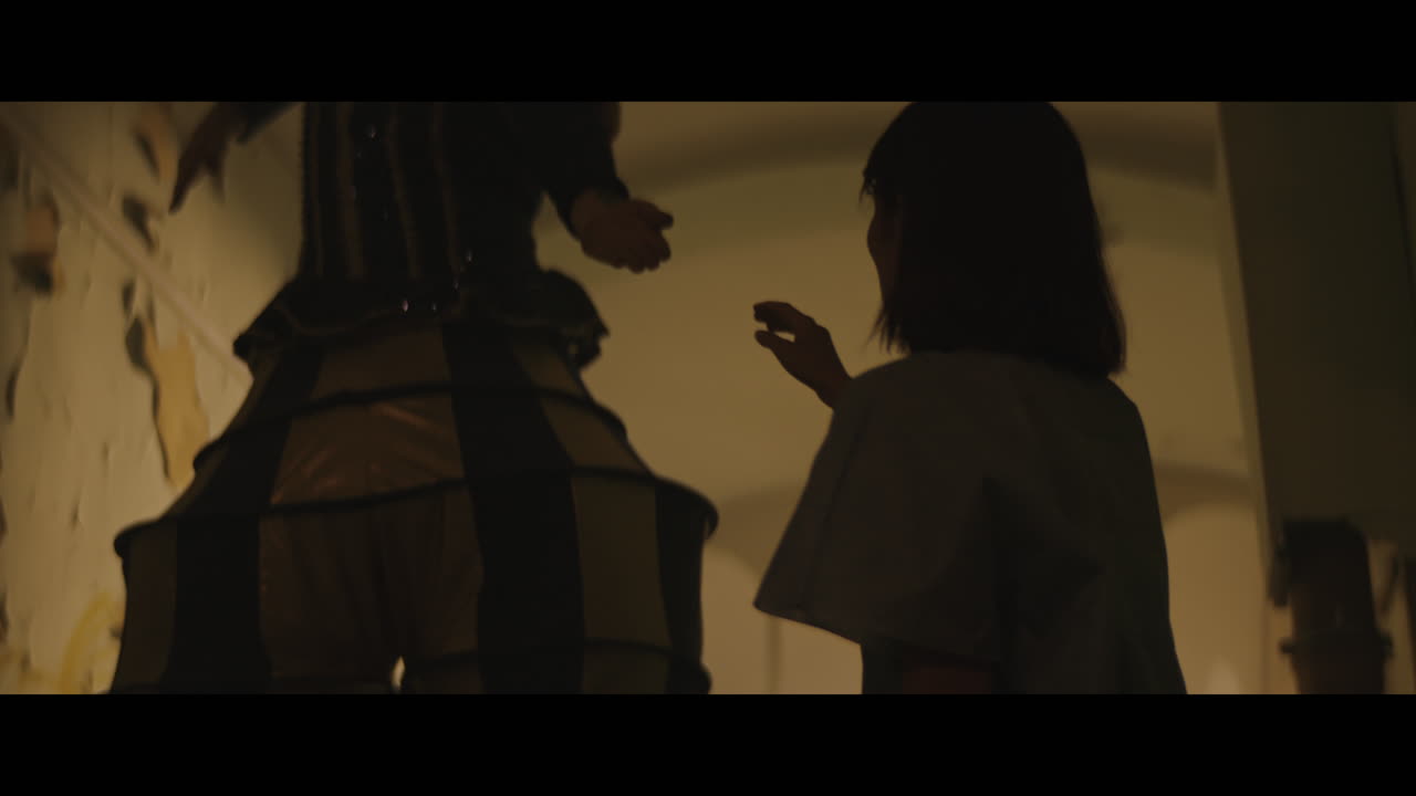 A strange clown on stilts in a dark corridor at night