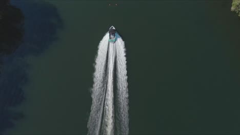 tracking a water ski boat from above, aerial shot