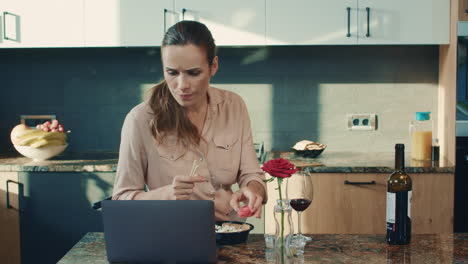 business woman reading news at luxury kitchen. sad woman preparing to eat sushi.