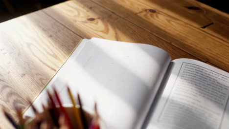 colored pencils in a bowl on a wooden table