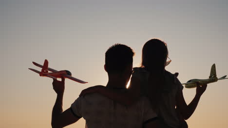 children play with toy airplanes girl with big brother have fun