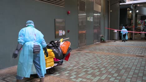 Gesundheitspersonal-Desinfiziert-Die-Straße-Vor-Einem-Gebäude,-Das-Unter-Sperrung-Gestellt-Wurde,-Nachdem-Eine-Große-Anzahl-Von-Einwohnern-In-Hongkong-Positiv-Getestet-Wurde