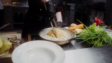 chef preparing spaghetti carbonara