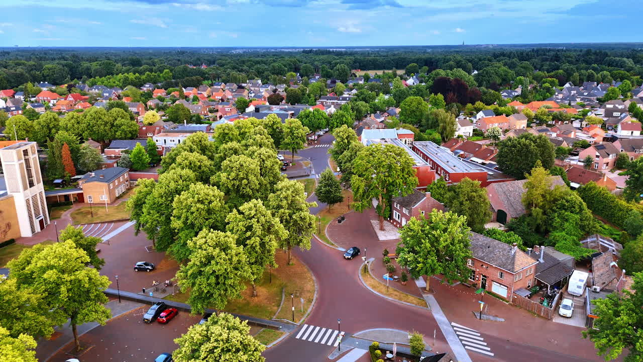 Flight over the lovely village of Oveloon in the Netherlands. Lush green forests around