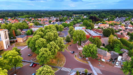 flight over the lovely village of oveloon in the netherlands. lush green forests around