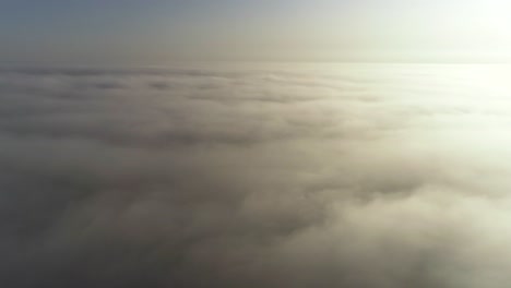 flight above clouds in morning golden hour