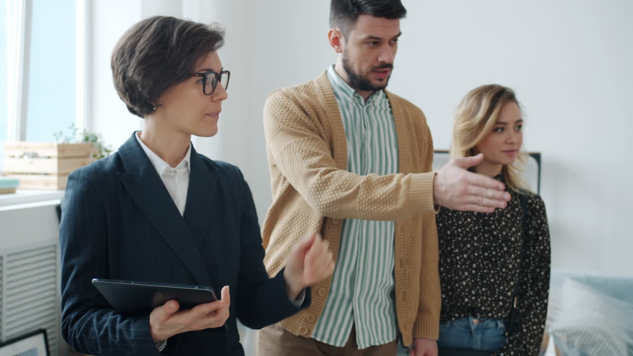 Real Estate Agent Showing a Property to Potential Buyers