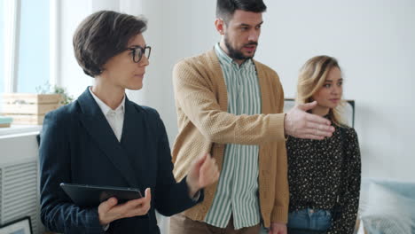 real estate agent showing a property to potential buyers
