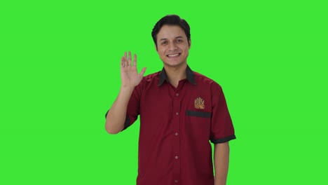 Happy-Indian-house-keeper-saying-hello-Green-screen