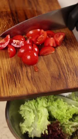 preparing a salad with sliced tomatoes and lettuce