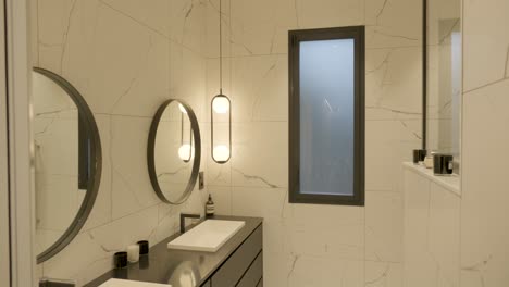 modern bathroom with two luxurious basins and round mirrors