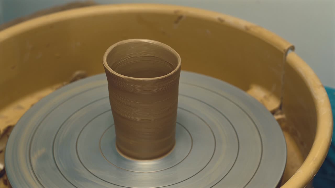 Close up footage of rotating pottery cup, manufacture