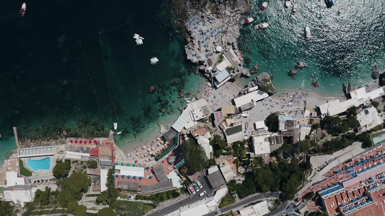 Top down aerial view of Capri, Italy's shoreline on a sunny day