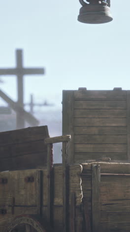 vintage wooden wagon with a cross in the background