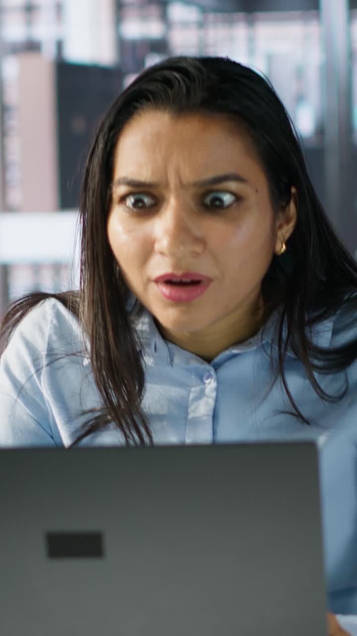 Woman Reacting with Shock and Distress While Working on Laptop