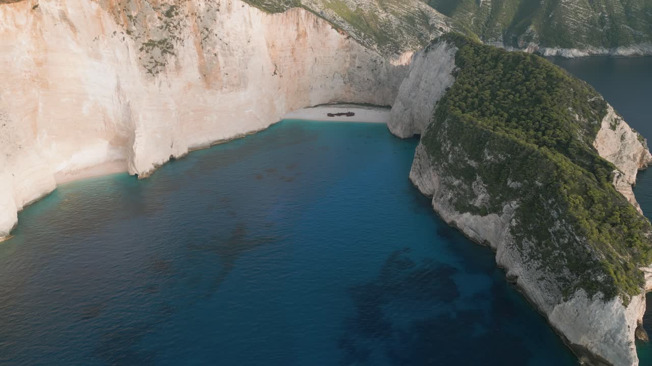 Rocky beach and clear blue water under bright sunlight, in Vietnam's natural beauty