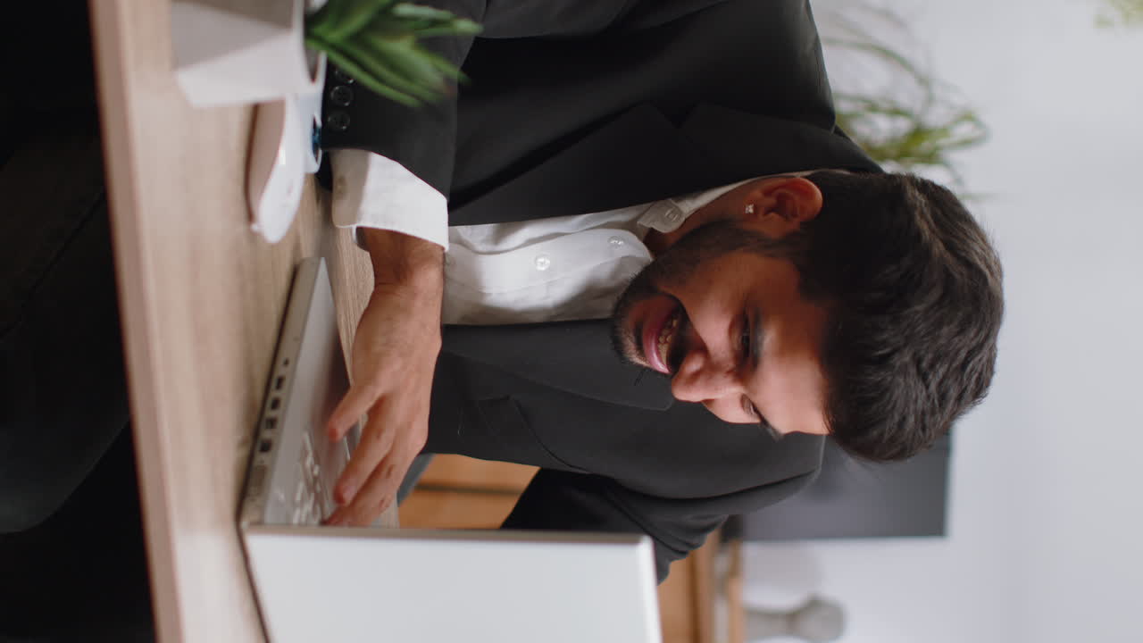 Business man winner working browsing typing on laptop at office celebrate big lottery win good news