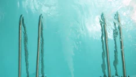 grab bar in a turquoise thermal spa pool