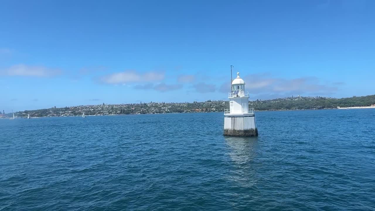 Passing white buoy slow motion on Port Jackson water in Sydney NSW Australia