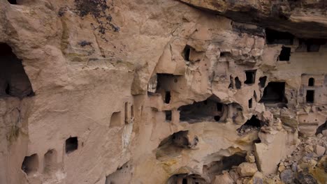 Close-aerial-view-of-Cavusin-fortress-and-church-Vaftizci-Yahya,-Saint-John-the-Baptist-in-Cappadocia,-Turkey