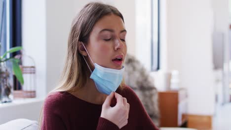 woman pulling down face mask to breathe