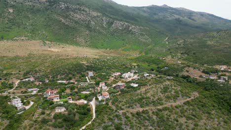 small village located on top of a hill surrounded by mountains