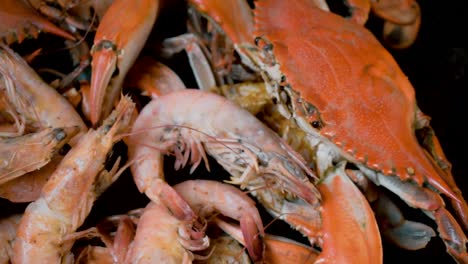 group of steaming hot blue crabs and large shrimp in pile