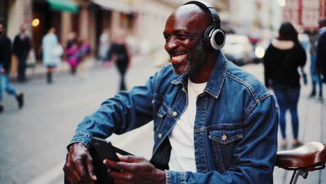 man with headphones on a city street