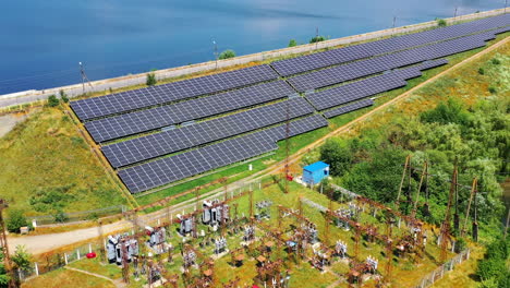solar farm in the countryside. large solar power station with blue sunny batteries on field. alternative source of sustainable energy. aerial view