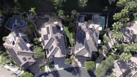 aerial birdseye view rising above modern wealthy calabasas homes with rooftop solar panels