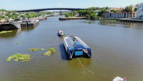 scenic shot with drone in orbit of interceptor 004, navigating the ozama river, dominican republic