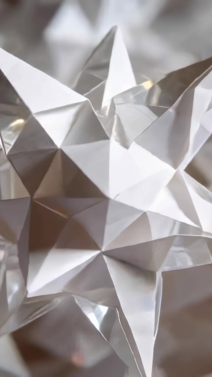 Vertical video: Camera sweep moving white star ornament showing facets in room with crystal glints