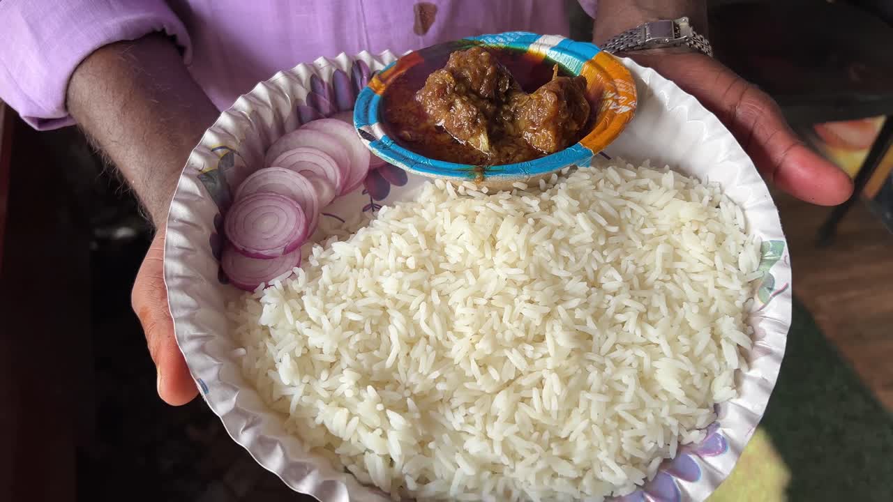 plato de carne de cordero servido con arroz blanco y cebollas.