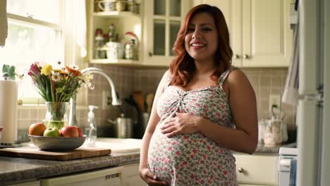 joyful anticipation: a beautiful pregnant woman smiling in a bright kitchen surrounded by fresh flowers and fruits, radiating happiness and love for the upcoming journey of parenthood