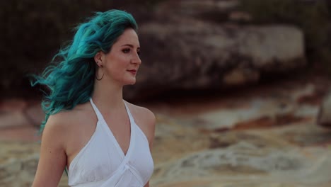 nature spirit - windswept flowing blue hair woman turns head left to right, twilight, shallow depth of field, slomo