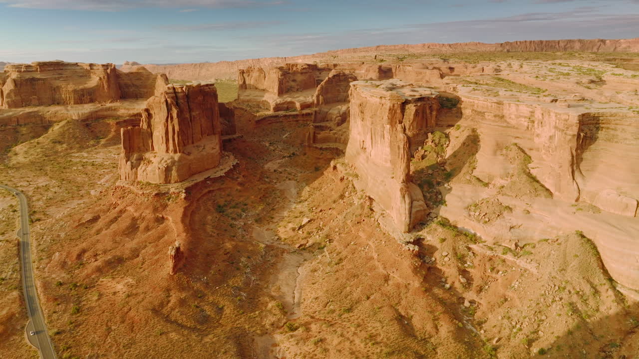 Curved rocks of amazing canyons in Utah, United States. Drone footage over the mountains and deserted land on sunny day.