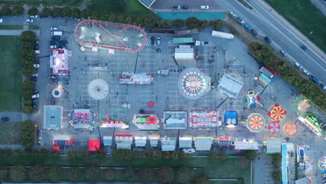 Aerial-top-down-timelapse-of-a-carnival-at-night-with-intense-lights-in-the-town-of-Alba,-Italy