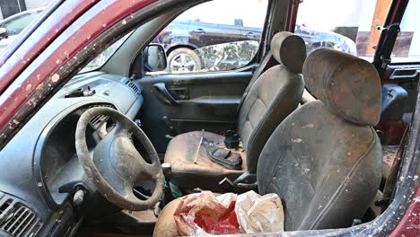 interior view of an old car, showcasing dusty seats and steering wheel, caused by flood damage in valencia
