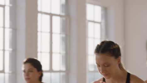 young pregnant caucasian woman in yoga class practicing warrior pose enjoying healthy lifestyle group exercising in fitness studio at sunrise