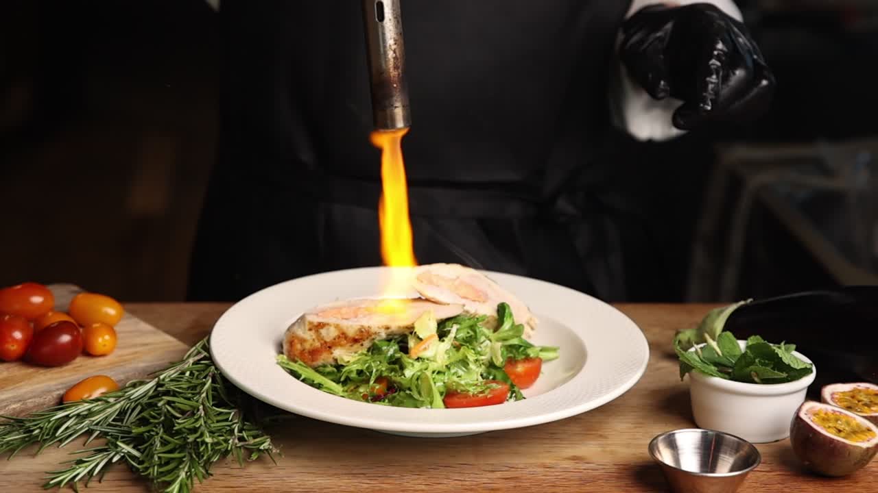 Chef Searing Gourmet Dish with Culinary Torch in a Professional Kitchen