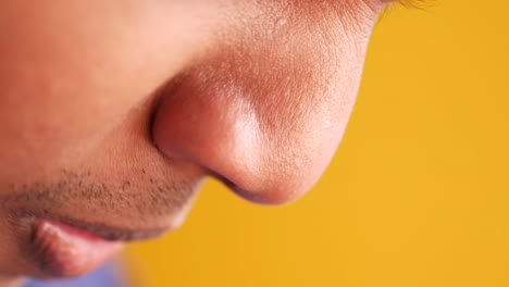 close-up of a person touching their nose