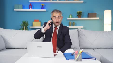 home office worker man getting good news on the phone.