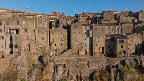 Ladera-Del-Acantilado-Del-Antiguo-Pueblo-De-Pitigliano-Se-Alza-Sobre-Una-Colina-Rocosa-De-Toba-En-Toscana,-Italia